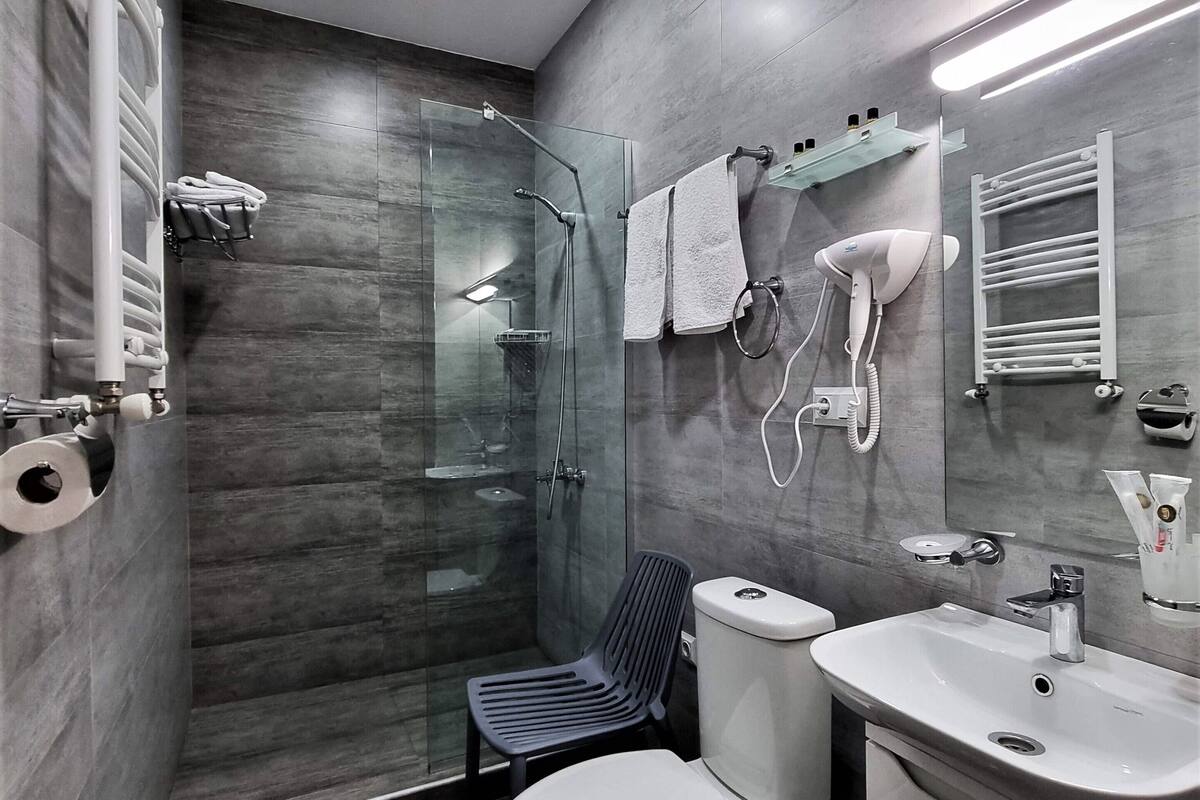 junior double room | bathroom | shower, rainfall showerhead, designer toiletries, hair dryer
