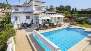 A poolside area with a pool, lounge chairs, and umbrellas. - Septimo Cielo by Interhome (Calpe/Calp)