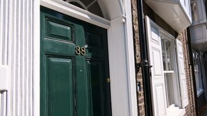 A green double door with the number 38, white trim, and a black metal handle. - Stodham House Quirky Central Townhouse, 4 beds sleeps up to 9 (York)