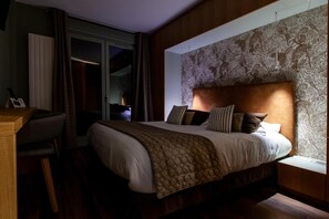 A bedroom with a large bed, a desk, and a window with a view. - Logis Hotel de la Tour (Dunieres)