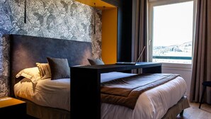 A bedroom with a bed, a desk, and a laptop. - Logis Hotel de la Tour (Dunieres)