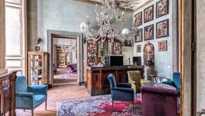 An opulent room with a bar, ornate ceiling, and classical artwork. - Palazzo Doria Napoli (Naples)