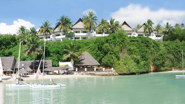 A beachfront resort with overwater bungalows, palm trees, and clear turquoise waters. - Mnarani Beach Club (Malindi)