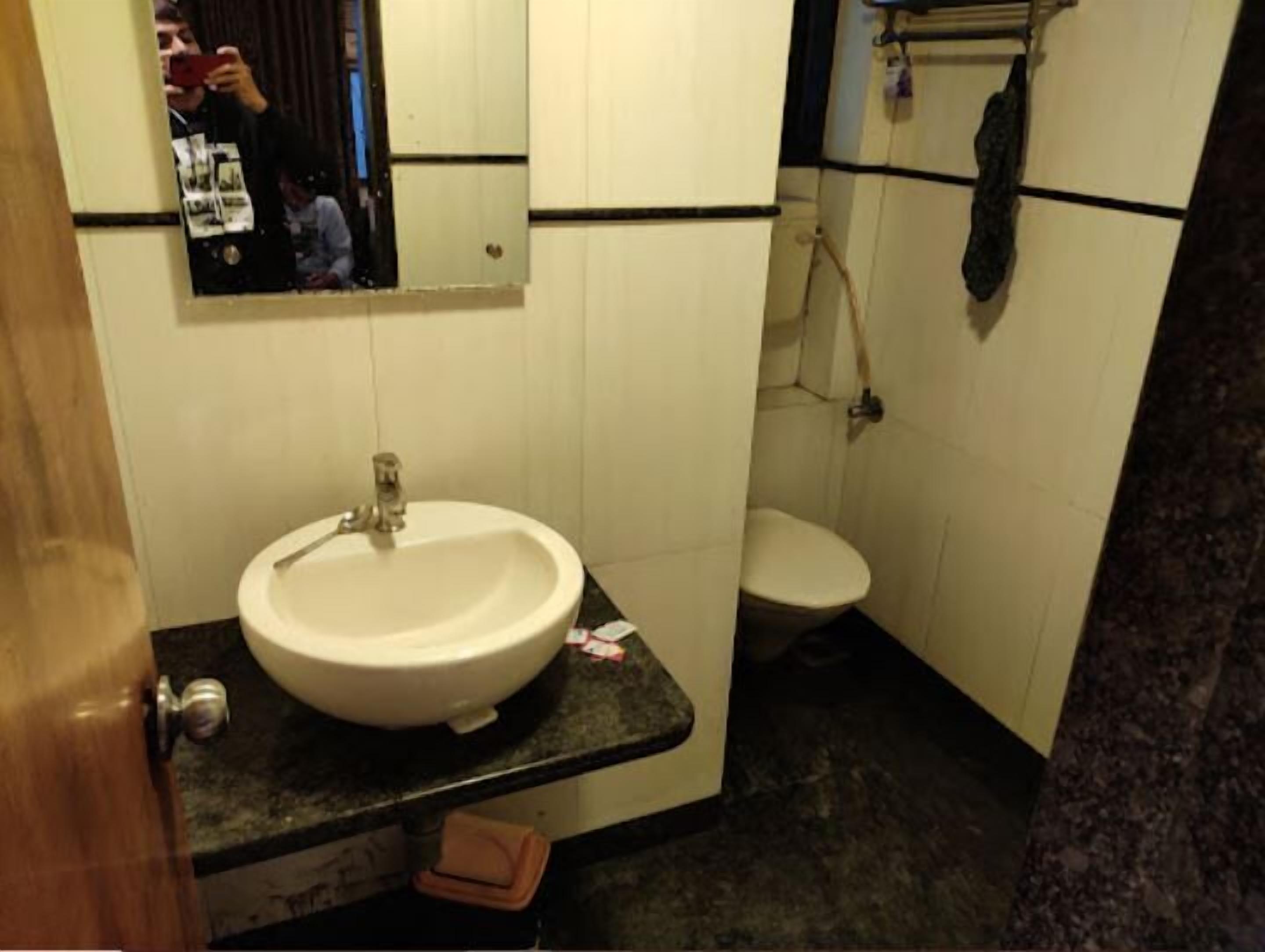 deluxe room | bathroom | shower, rainfall showerhead, towels, soap