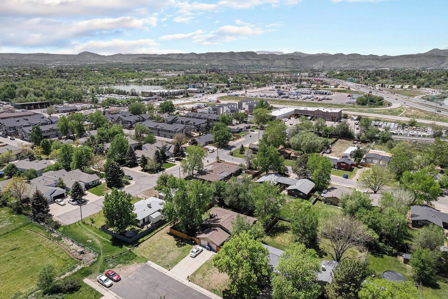 A residential area with houses, roads, and a highway.