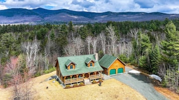 Set amidst dense forest and rolling hills, this lodge offers a spacious front porch and separate garage.
