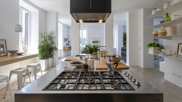 A modern kitchen with a central island, stainless steel appliances, and white cabinetry. - GuestHost - Large and bright 200sqm apartment, able to accommodate up to 7 people, located on the 3rd floor with elevator (not suitable for disabled people) of a building dating back to the 19th century. The property overlooks Piazza Fanti's garden and i (Roma)