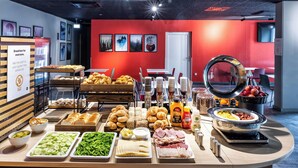 A breakfast buffet with various food items and a coffee station. - B&B Hotel Maribor (Maribor)