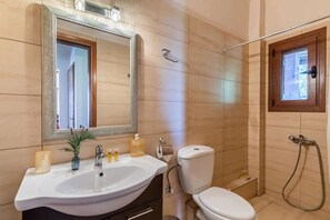 Bathtub, hair dryer, towels, toilet paper