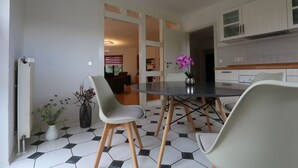 A modern kitchen with white cabinets and a black and white tiled floor. - Wonderful vacation apartment on the Wieker Bodden (Wiek)