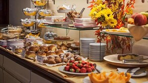 A buffet with various food items including pastries, fruits, and a cake. - Hotel Scandinavia (Massa)