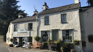 A white building with a sign for 'The Coppermines Lakescot Tags'. - Lake District village apartment with private riverside hot tub (Coniston)