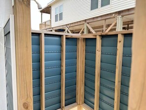 A corner of a building with a wooden structure and a blue exterior wall.