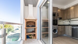 A modern kitchen with a built-in oven, microwave, and dishwasher.
