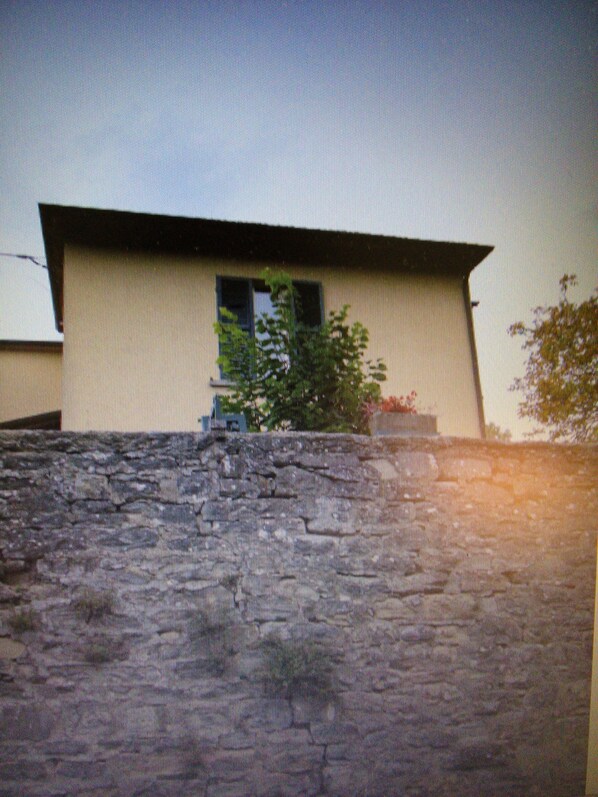 A building with a sloped roof and a window.