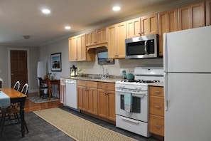 Enjoy cooking in this well-equipped kitchen with a gas stove, refrigerator, and microwave.