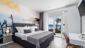 A modern hotel room with a large bed, a desk, and a view of the sea. - Villa BAMM with heated 36sqm pool, 5 en-suite bedrooms, and panoramic sea views (Borak)