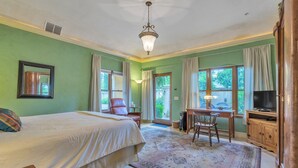 A bedroom with a bed, a desk, a chair, a television, and a cabinet. - Cypress House & Studio, Walk To Healdsburg Plaza 3 Bedroom Home by RedAwning (Healdsburg)
