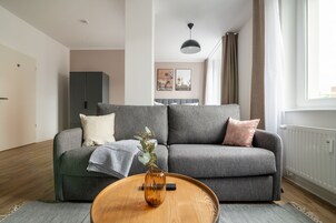 Suite with sofa bed | Living area | 50-inch LCD TV with satellite channels, TV