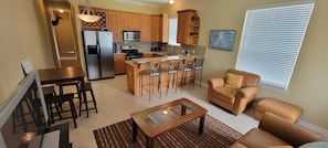 Relax in the living room with a comfortable sofa, coffee table, and dining area.