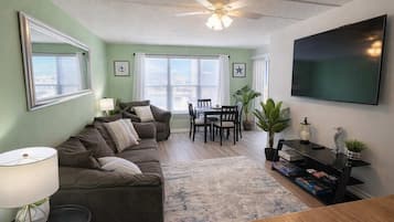 Appartement, meerdere bedden, patio, gedeeltelijk uitzicht op oceaan | Woonruimte | Een televisie