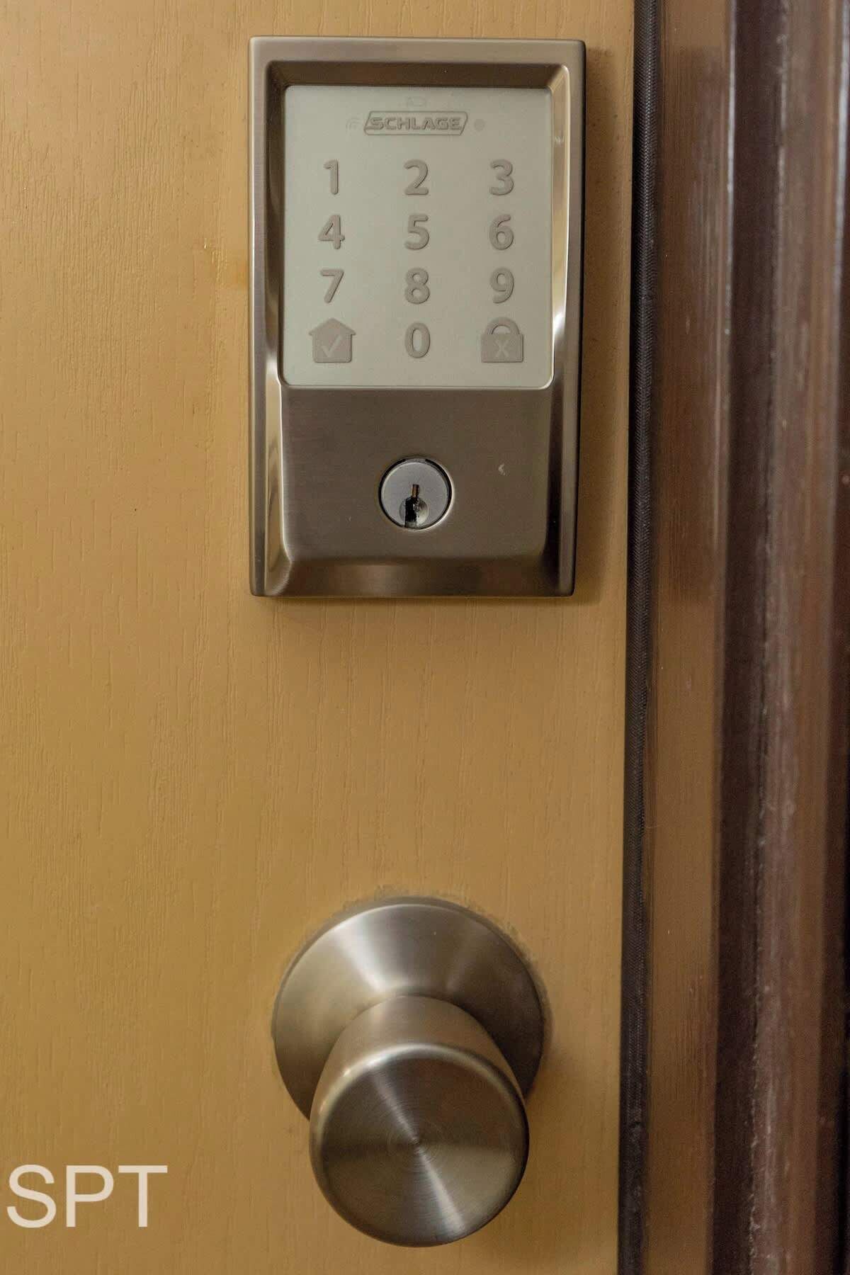 A door with a numeric keypad and a round, metallic door handle.