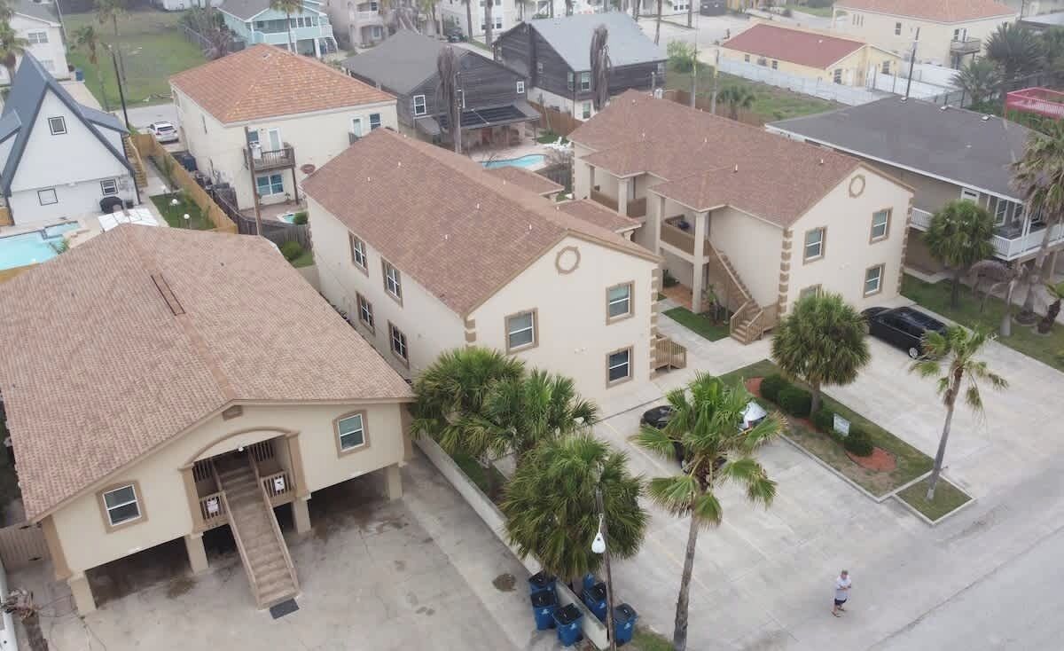 A residential area with multiple two-story houses, each with a tiled roof and a front porch.