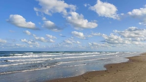 A beach with waves and a clear sky. - Heated Pool - Sleeps Many Beachfront Resort (South Padre Island)