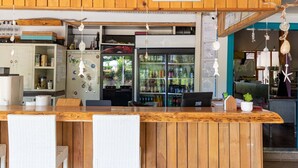 A reception area with a wooden counter, white chairs, and a sign labeled "reception". - Jasmin Pansiyon (Kemer)