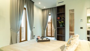 A modern bedroom with a large bed, a bedside table, a nightstand, a window with curtains, a bookshelf, and a view of the outside balcony. - De Gulia Charme and Relax (Castellabate)