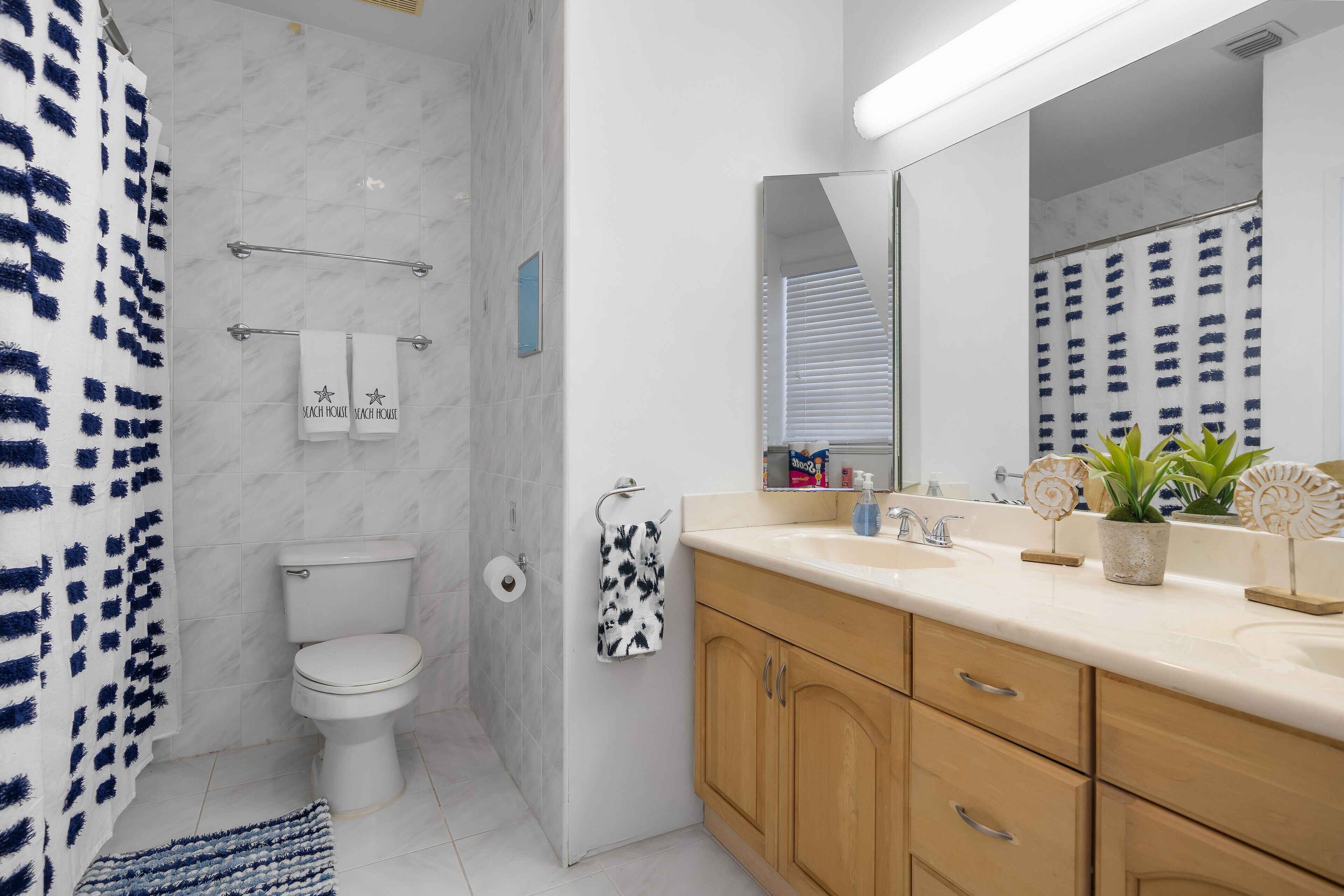 A modern bathroom with a toilet, sink, and shower area.
