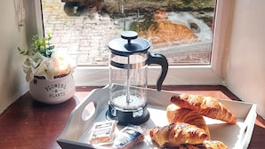 A tray with croissants and a coffee maker on a windowsill. - Charming Stone Parlour Cottage set in an area of outstanding beauty. (Biggar)