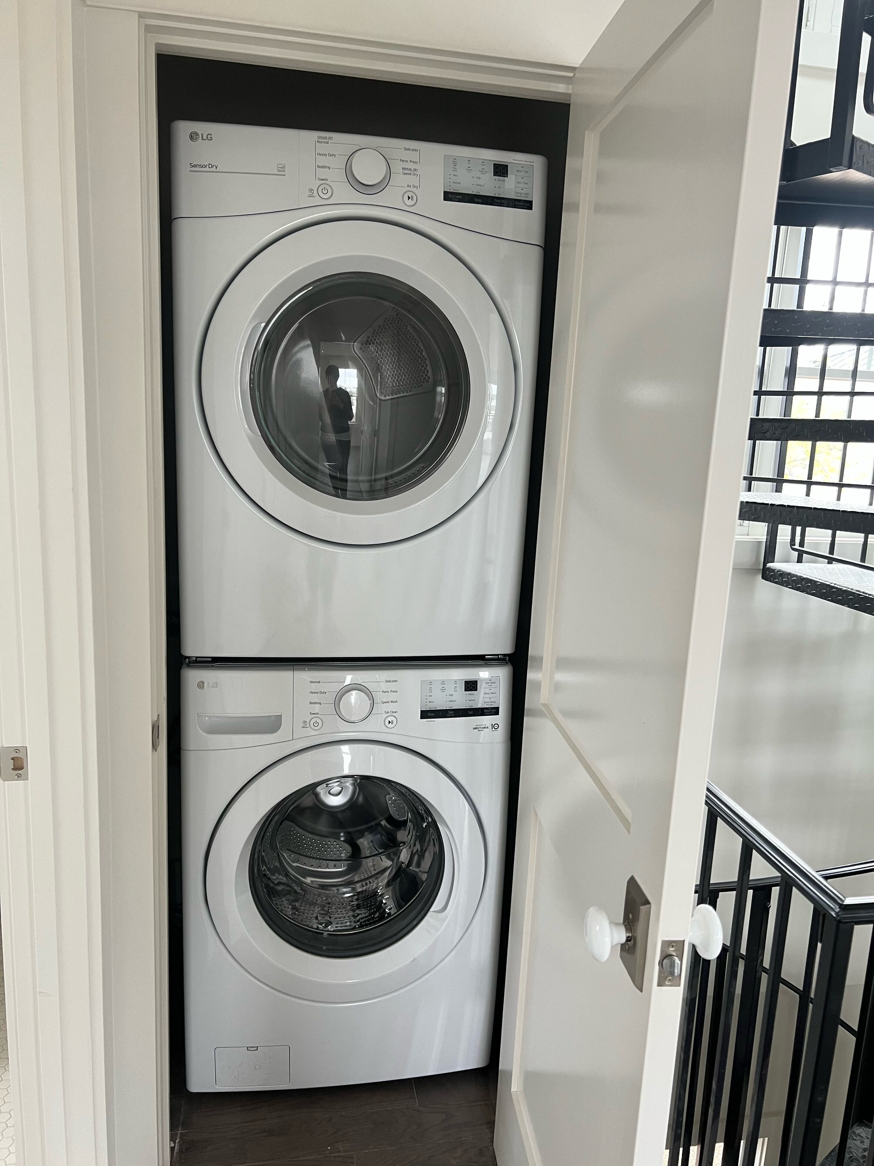 A laundry room with two stacked front-loading washing machines.