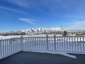 Escape to a serene winter wonderland with breathtaking mountain views from this peaceful outdoor space.