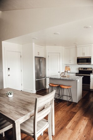 Enjoy cooking in this well-equipped kitchen with a central island and stainless steel appliances.