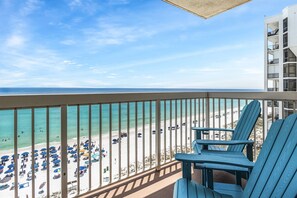 A balcony with a view of a beach and ocean.