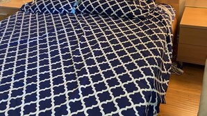 A neatly made bed with a patterned bedspread, a wooden headboard, and a nightstand with a lamp. - Queen Suite full bath  1-3 guest  minute to school shopping etc .優雅套房。交通方便。赞👍 (Hacienda Heights)