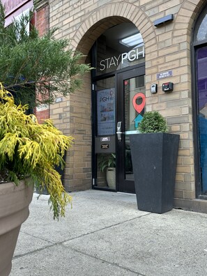 A brick building with a large arched entrance labeled "STAYPGH". - Stay Pittsburgh (Pittsburgh)