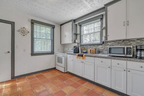 Enjoy cooking in this well-equipped kitchen with an oven, microwave, coffee maker, and kettle.