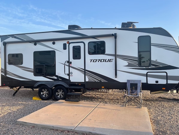 A white RV with black accents and the word "TORQUE" on the side.