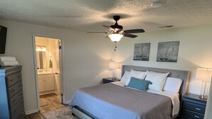 A bedroom with a bed, nightstands, a dresser, a ceiling fan, and artwork on the wall. - Lakeside Retreat with Dock/Porch/Firepit/Beach (Fort McCoy)