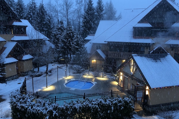 A snowy courtyard setting view from one of two balconies.