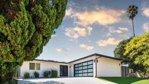 A modern two-story house with a garage, surrounded by well-maintained lawns and mature trees. - calabasas Home With stunning Views, Pool, and Jacuzzi  (Calabasas)
