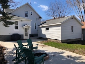 A two-story house with a covered patio area.