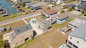 An aerial view of a residential area with houses, a swimming pool, and a dock. - Private Beach House, Pet Friendly, Close To Beach + Free Attraction Tickets! (North Myrtle Beach)