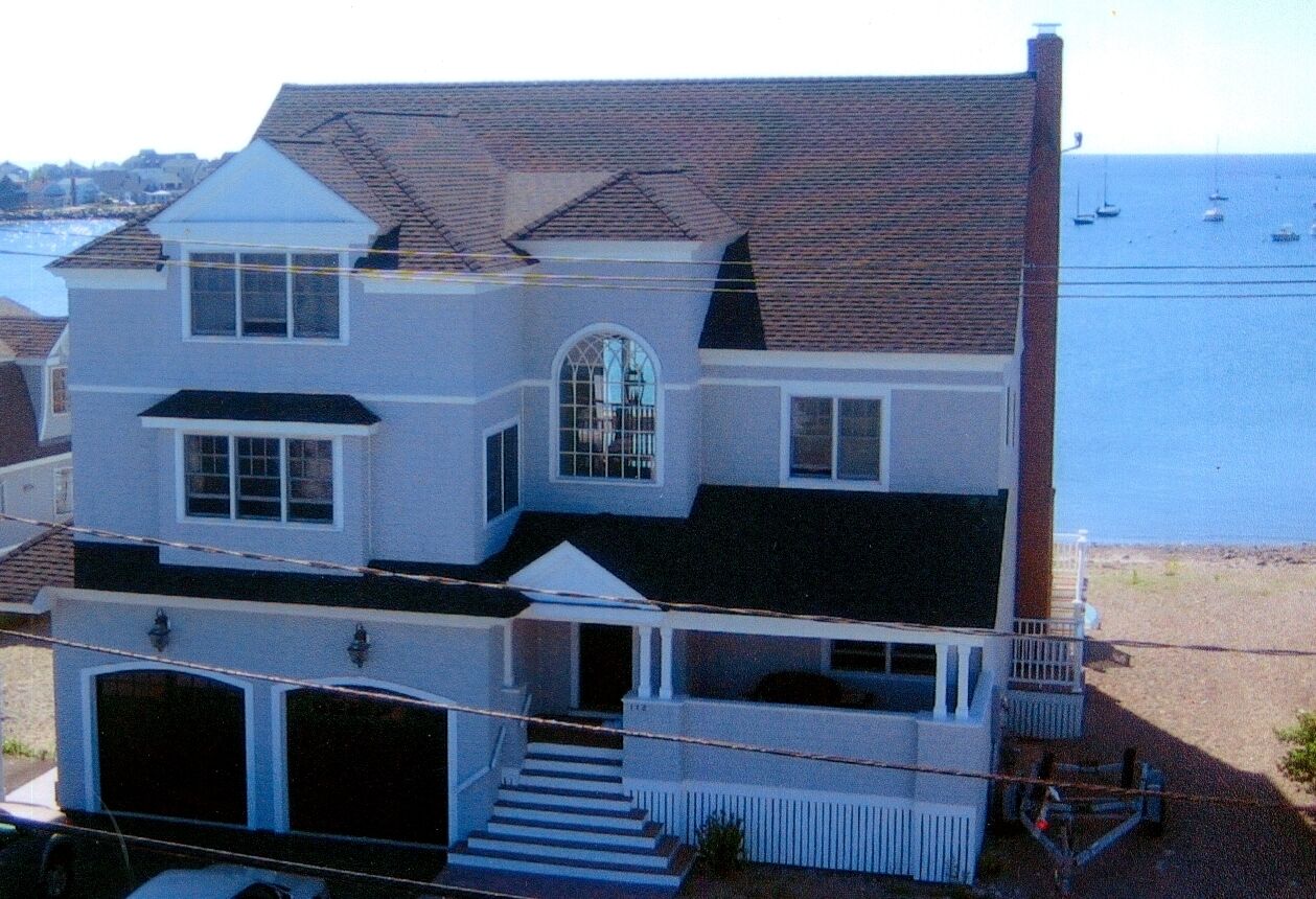 Breathtaking harbor views from spacious beachfront home.