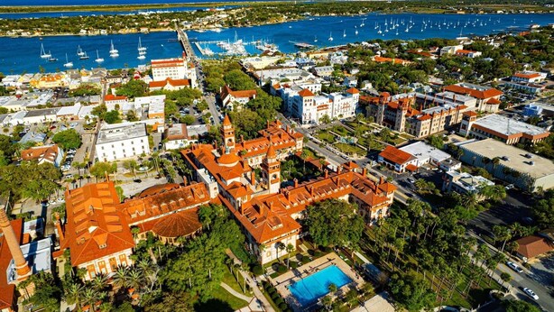 An aerial view of a coastal town with historic buildings, a marina, and a large pool area. - Cheerful studio by LionsBridge, short 🚶‍♀️to downtown. (St. Augustine)