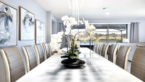A long dining table with a black centerpiece, surrounded by leather chairs. - Last Minute Disney! Private Pool, Hot Tub, Game Room & Themed Bedrooms. Book Now! #56669 (Orlando)