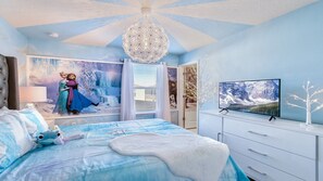 Relax in a stylish bedroom with a large bed, wall mural, and flat-screen TV.