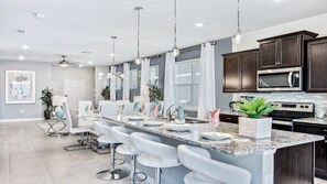 Enjoy cooking in this well-equipped kitchen with a central island and bar stools.